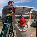Farmers installing solar panels