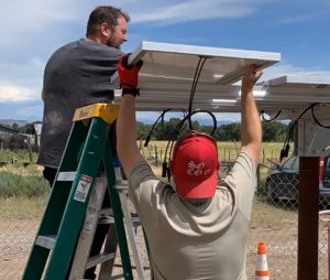 Farmers installing solar panels