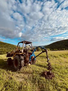 Machinery digging hole for fence post